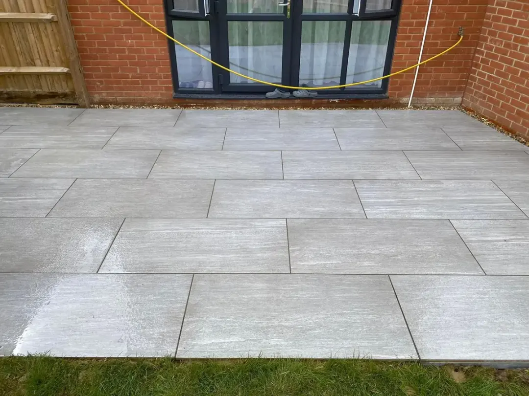 Freshly laid grey porcelain patio outside patio doors