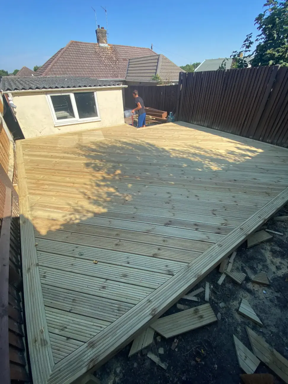 New large timber deck being finished in a back garden